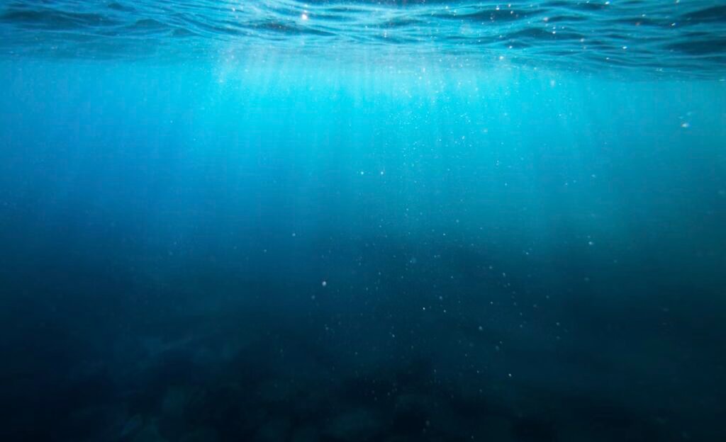 Sunlight filtering through deep blue open ocean water
