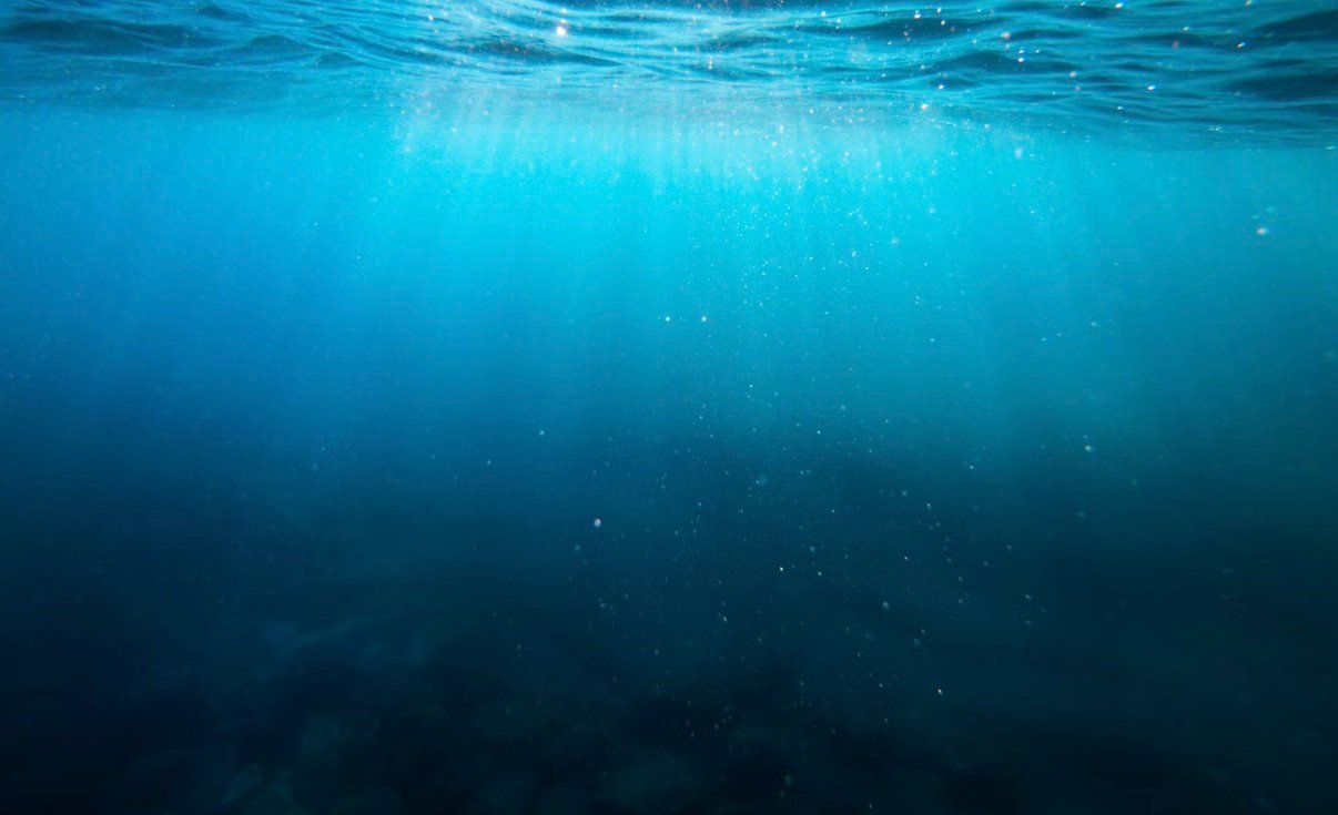 Sunlight filtering through deep blue open ocean water
