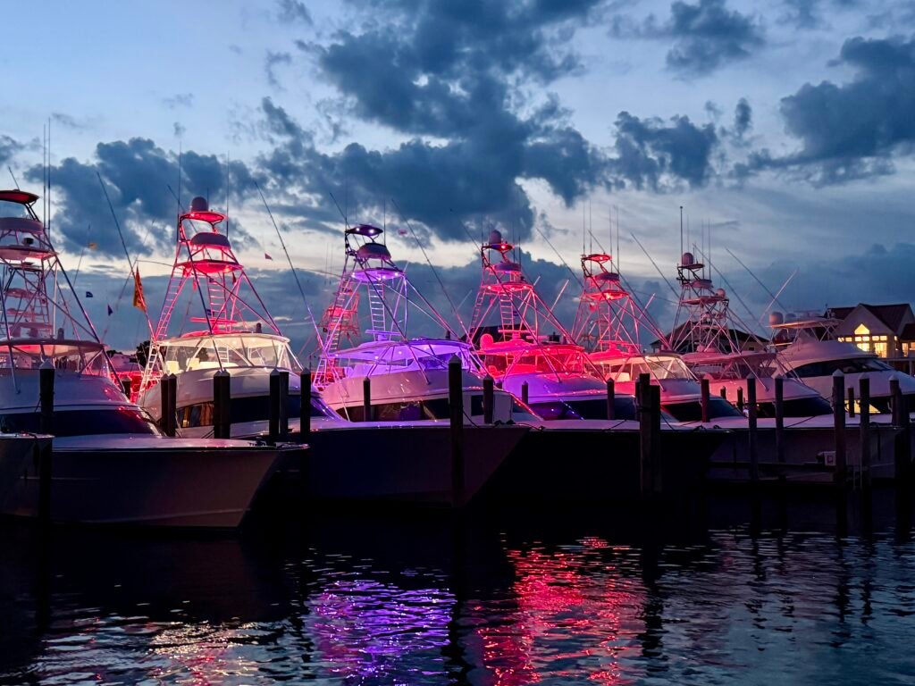 Evening falls on Sunset marina and the Sportfishers light up.