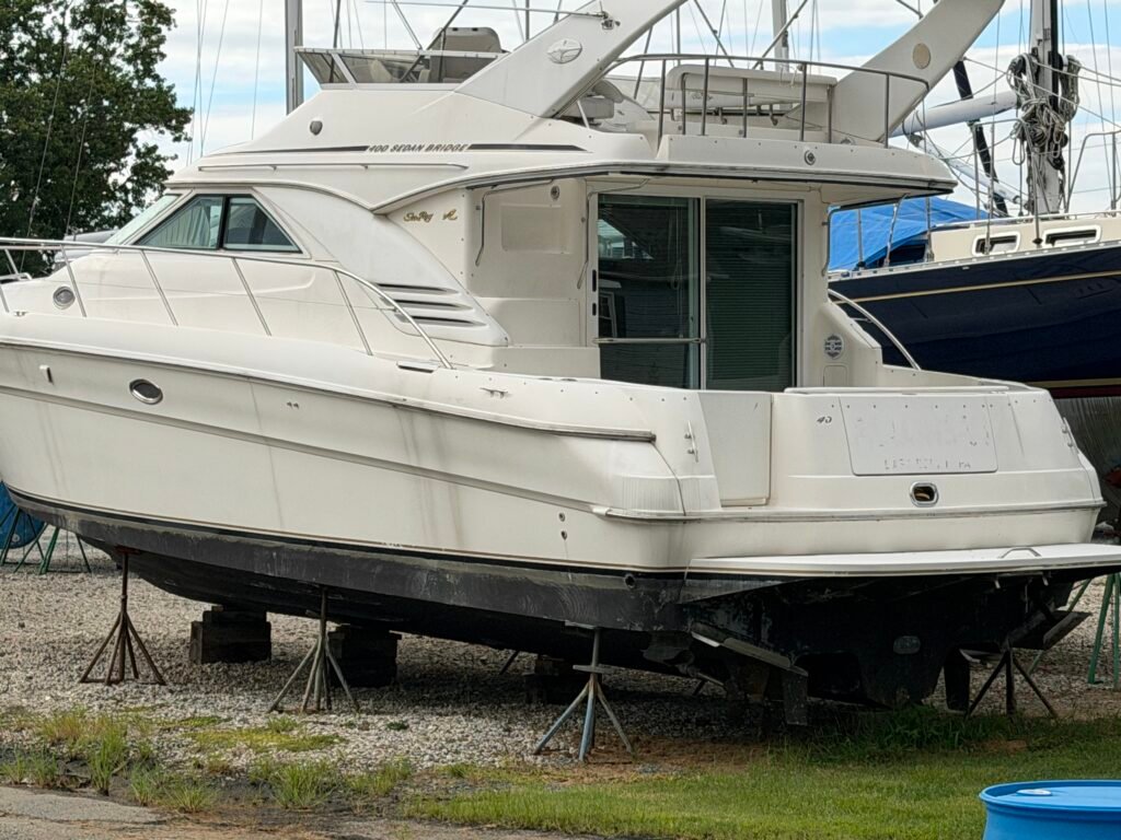 Older 40' Sea Ray on the hard, waiting for a good cleaning and bottom paint.
